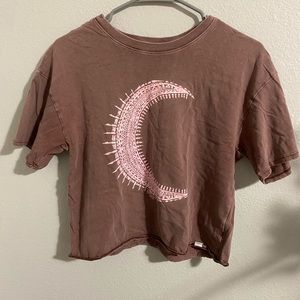 it’s a brown with a pink moon cropped shirt